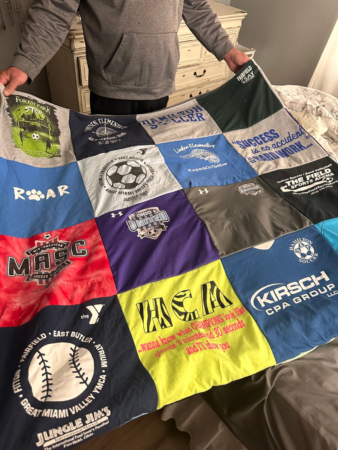 Custom graduation quilt featuring sports jerseys and school shirts — handmade in North Carolina